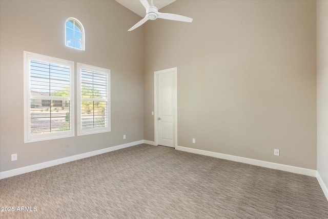 8599 E Sand Flower Dr, Scottsdale, AZ 85266 - spare room with a ceiling fan, baseboards, a high ceiling, and carpet floors