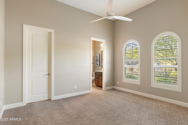 8599 E Sand Flower Dr, Scottsdale, AZ 85266 - unfurnished bedroom featuring ensuite bath, baseboards, and light colored carpet