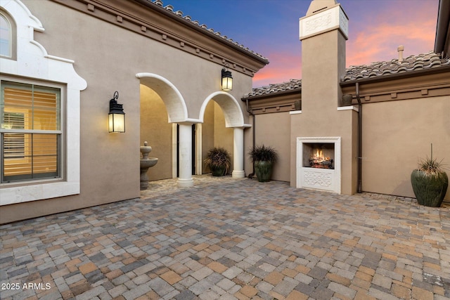 8599 E Sand Flower Dr, Scottsdale, AZ 85266 - view of patio featuring a lit fireplace