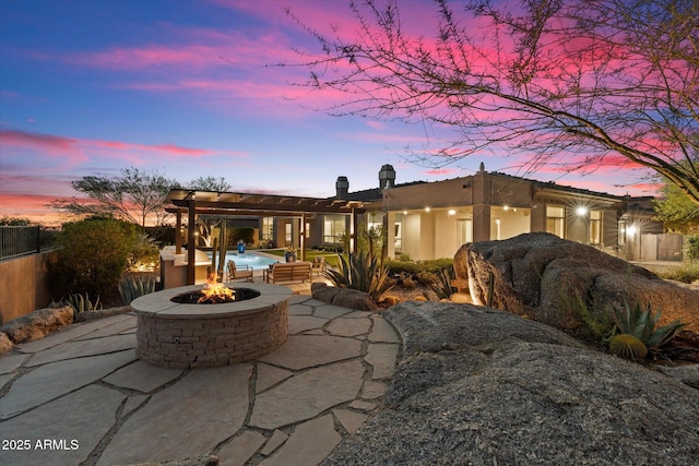 8599 E Sand Flower Dr, Scottsdale, AZ 85266 - back of house featuring a patio area, a chimney, an outdoor fire pit, fence, and stucco siding