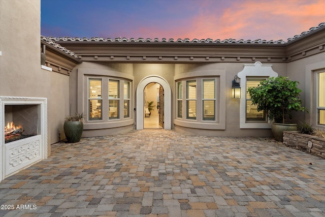 8599 E Sand Flower Dr, Scottsdale, AZ 85266 - patio terrace at dusk featuring a lit fireplace