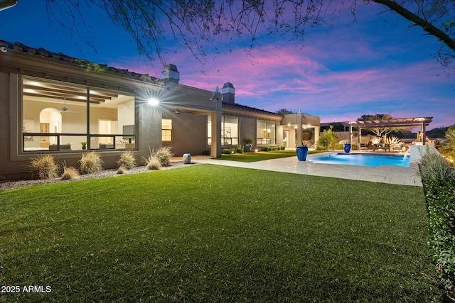 8599 E Sand Flower Dr, Scottsdale, AZ 85266 - back of house with a pergola, a lawn, an outdoor pool, and stucco siding