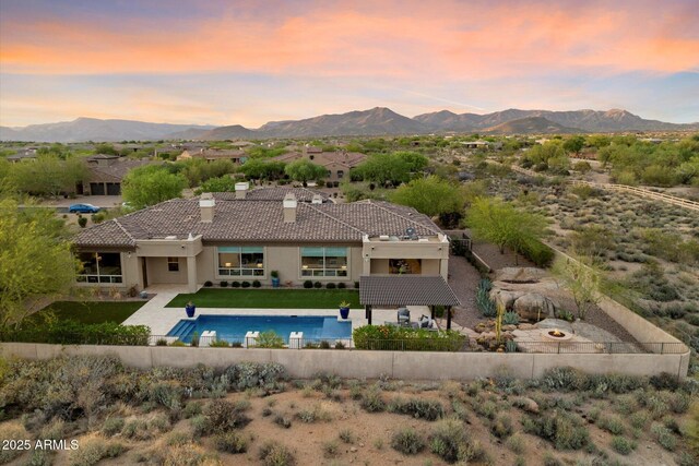8599 E Sand Flower Dr, Scottsdale, AZ 85266 - pool at dusk featuring fence, a fenced in pool, and a mountain view