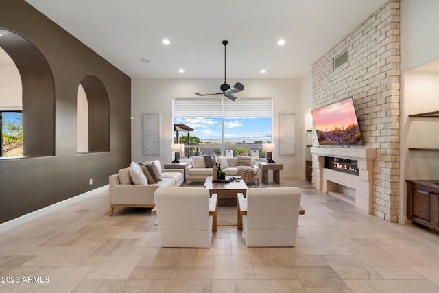 8599 E Sand Flower Dr, Scottsdale, AZ 85266 - living area with baseboards, a ceiling fan, a brick fireplace, and recessed lighting
