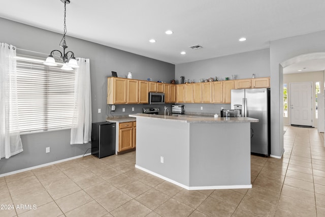 kitchen with a kitchen island with sink, stainless steel appliances, a notable chandelier, decorative light fixtures, and light tile patterned floors