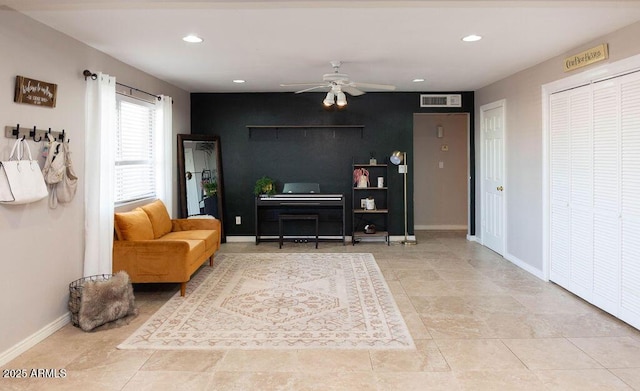 sitting room with a ceiling fan, visible vents, baseboards, an accent wall, and recessed lighting