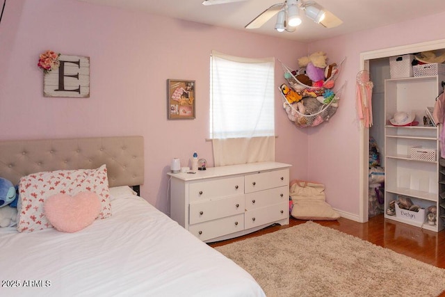 bedroom featuring baseboards, ceiling fan, and wood finished floors