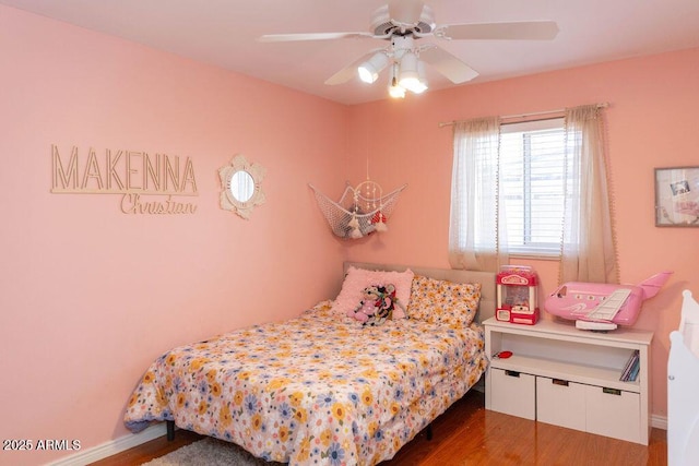 bedroom featuring baseboards, ceiling fan, and wood finished floors
