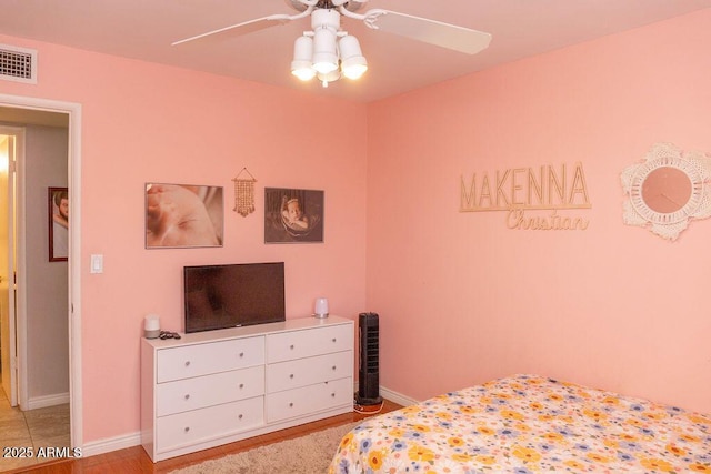 bedroom with baseboards, ceiling fan, and visible vents