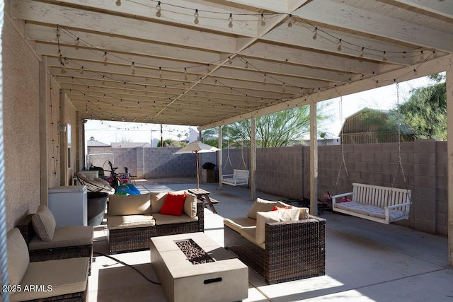 view of patio / terrace featuring a fenced backyard and an outdoor living space with a fire pit