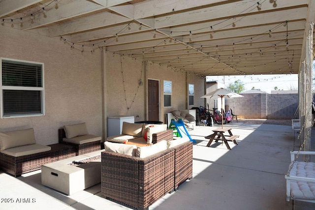 view of patio / terrace featuring a fenced backyard and an outdoor living space with a fire pit