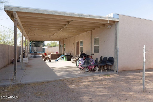 view of patio / terrace featuring a fenced backyard and a trampoline