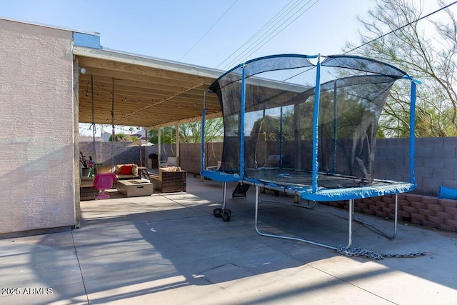 view of patio featuring a fenced backyard and a trampoline