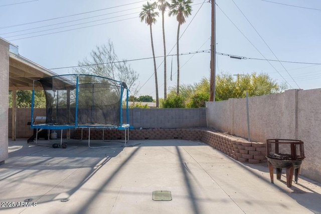 view of patio featuring a fenced backyard and a trampoline