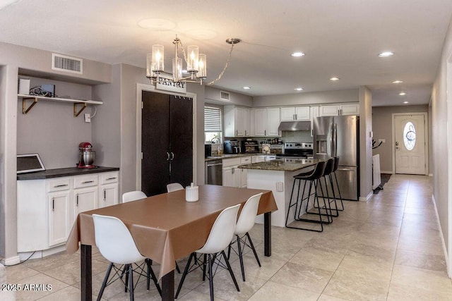 dining space with light tile patterned flooring, recessed lighting, a chandelier, and visible vents