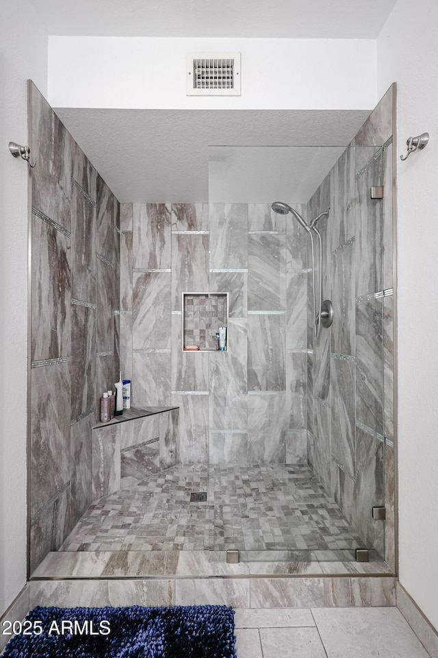 bathroom featuring a shower stall and visible vents