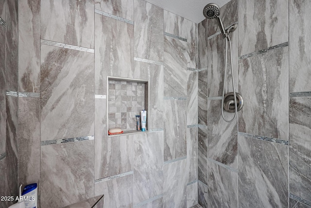 bathroom with a tile shower