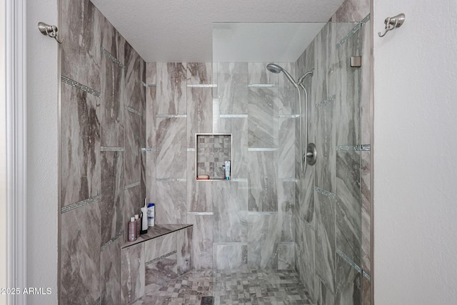 full bathroom with a stall shower and a textured ceiling