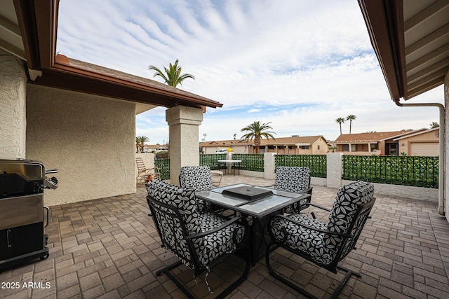 view of patio / terrace featuring outdoor dining space, fence, and grilling area