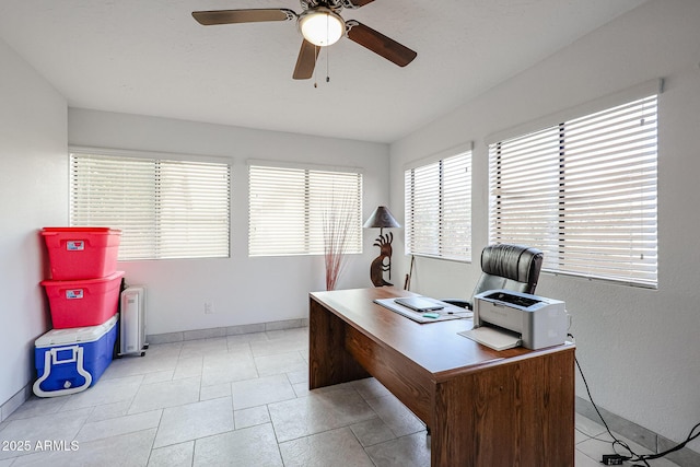 office area featuring ceiling fan and baseboards