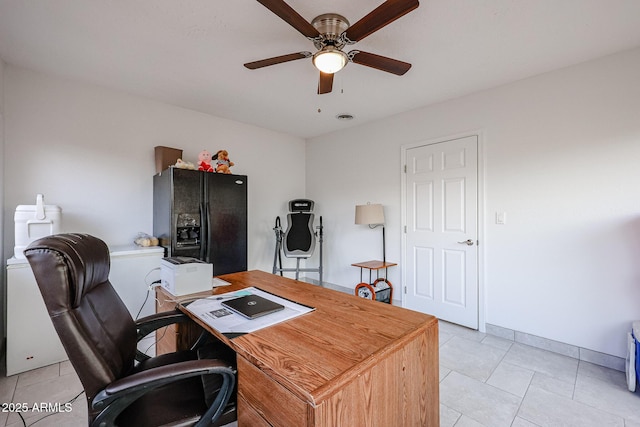 office space featuring ceiling fan, light tile patterned floors, visible vents, and baseboards