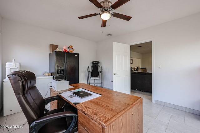 home office with a ceiling fan, baseboards, and light tile patterned floors