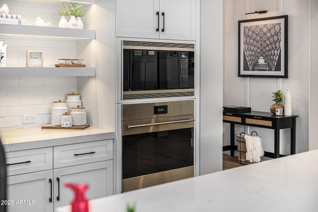 kitchen featuring open shelves, tasteful backsplash, white cabinetry, stainless steel oven, and built in microwave