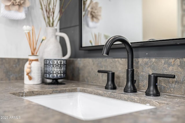 interior details with decorative backsplash and a sink