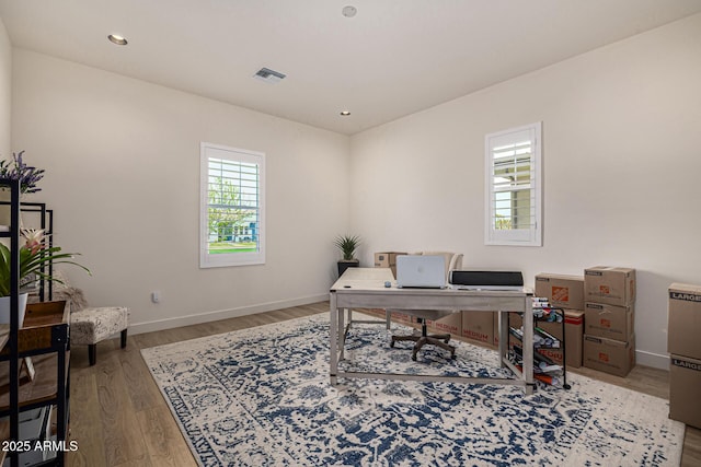 office featuring recessed lighting, visible vents, baseboards, and wood finished floors