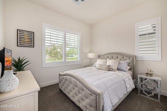 bedroom with visible vents, dark colored carpet, and baseboards