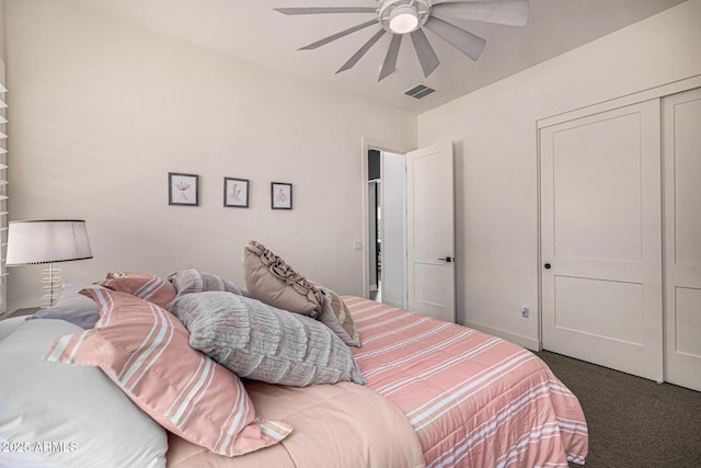 bedroom featuring baseboards, visible vents, carpet floors, ceiling fan, and a closet