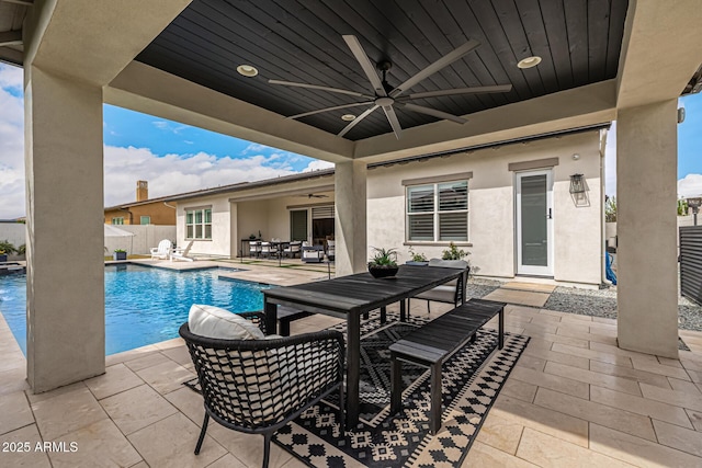 view of pool with a fenced in pool, fence, outdoor dining area, ceiling fan, and a patio area