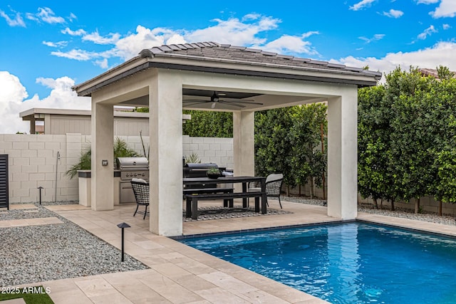 view of pool featuring exterior kitchen, a gazebo, a fenced backyard, a patio area, and a grill