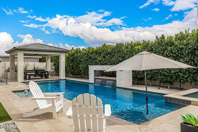 view of pool featuring a fenced in pool, a patio area, a fenced backyard, and exterior kitchen