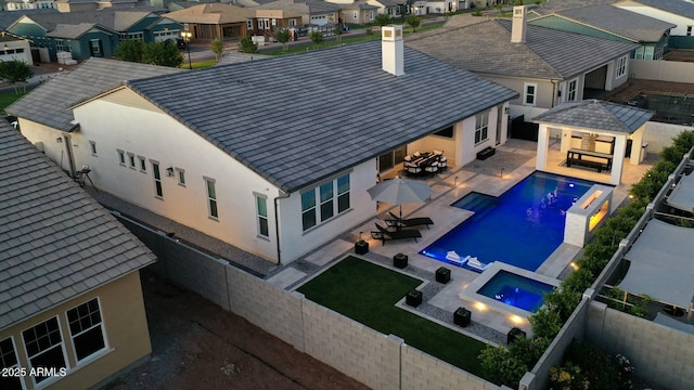 view of pool featuring a gazebo, a fenced backyard, a residential view, and a fire pit