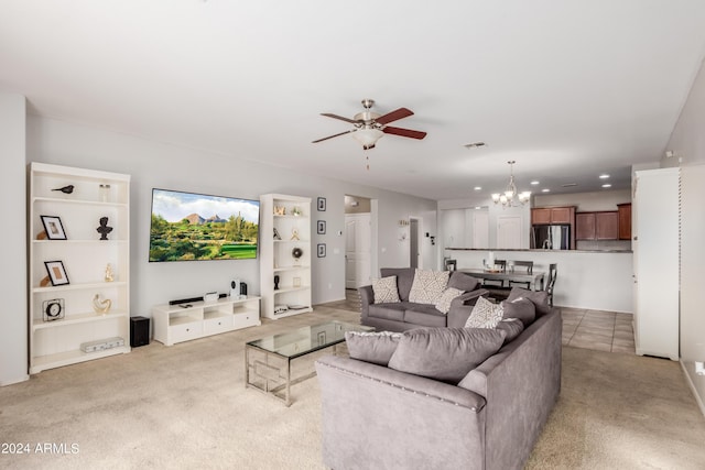 carpeted living room featuring ceiling fan with notable chandelier and built in features