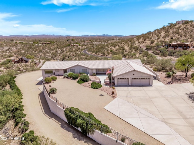 birds eye view of property featuring a mountain view and view of desert