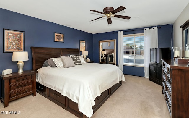 bedroom featuring light carpet and ceiling fan