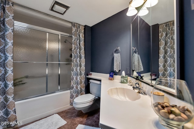 full bathroom with tile patterned flooring, vanity, bath / shower combo with glass door, and toilet