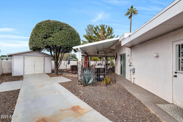 view of yard featuring a shed and a patio area