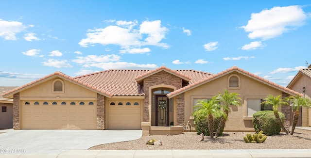 11320 E Newcastle Ave, Mesa, AZ 85209 - mediterranean / spanish-style house featuring a garage, stucco siding, concrete driveway, stone siding, and a tile roof