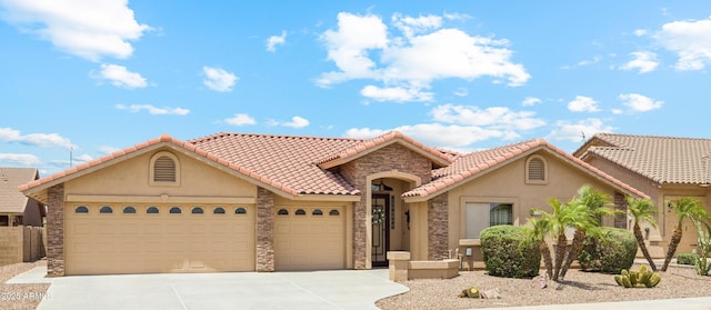 11320 E Newcastle Ave, Mesa, AZ 85209 - mediterranean / spanish home with an attached garage, driveway, stucco siding, and stone siding