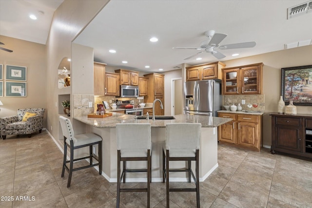11320 E Newcastle Ave, Mesa, AZ 85209 - kitchen with appliances with stainless steel finishes, ceiling fan, a peninsula, decorative backsplash, and recessed lighting
