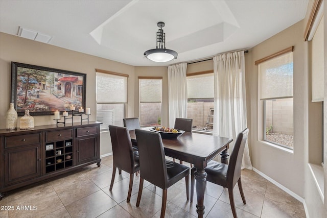 11320 E Newcastle Ave, Mesa, AZ 85209 - dining area with a raised ceiling, light tile patterned floors, and baseboards