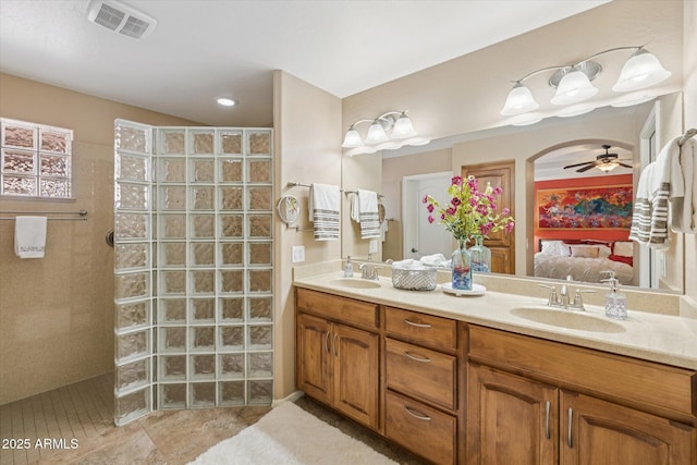 11320 E Newcastle Ave, Mesa, AZ 85209 - ensuite bathroom with a walk in shower, double vanity, a ceiling fan, and tile patterned flooring