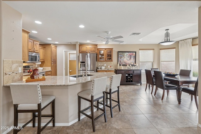 11320 E Newcastle Ave, Mesa, AZ 85209 - kitchen with appliances with stainless steel finishes, tasteful backsplash, a peninsula, a kitchen breakfast bar, and recessed lighting