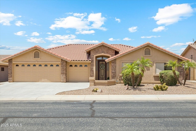 11320 E Newcastle Ave, Mesa, AZ 85209 - mediterranean / spanish-style house featuring a garage, stucco siding, concrete driveway, stone siding, and a tile roof