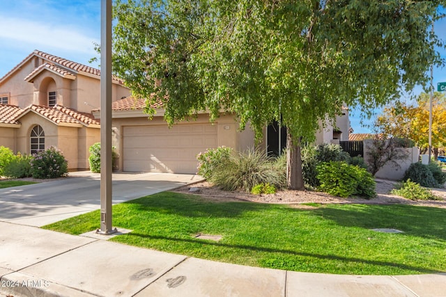 view of front of home with a garage and a front lawn