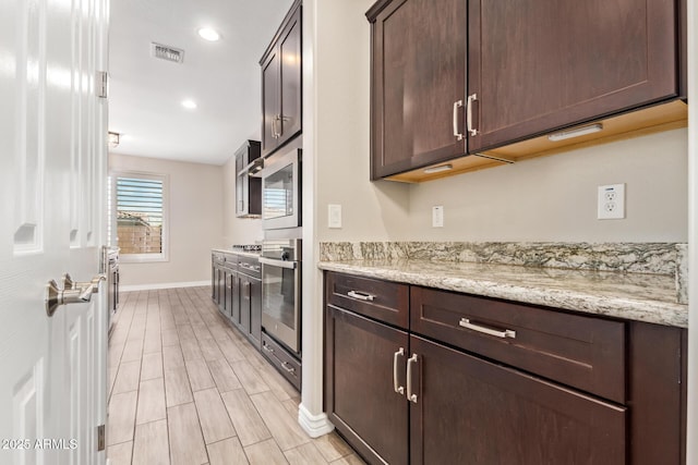 kitchen with appliances with stainless steel finishes, baseboards, dark brown cabinets, recessed lighting, and light wood-style flooring