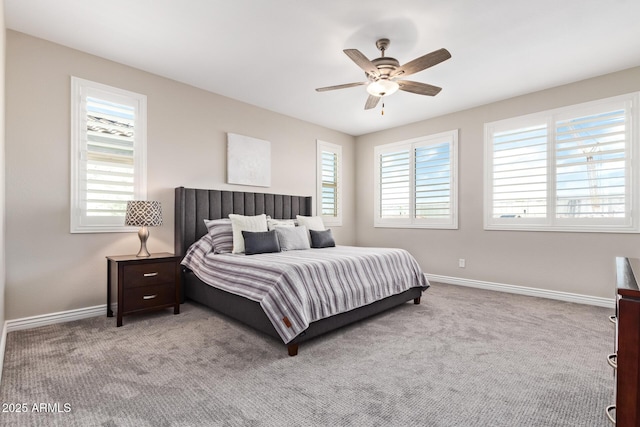 carpeted bedroom with baseboards and a ceiling fan